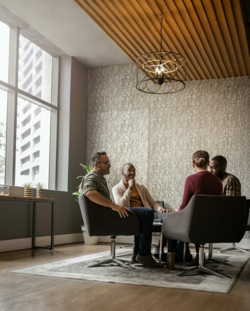 A small group of businesspeople talking in an office